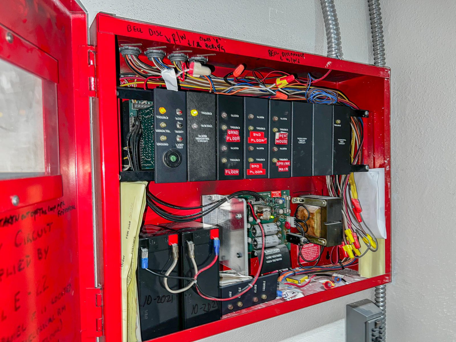 Diligence Security fire watch Officer inspecting a fire alarm control panel in Seattle